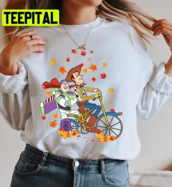 Disney Toy Story Woody And Buzz Lightyear Riding Bike Fall Autumn Leaves Halloween Fall Trending Unisex Shirt